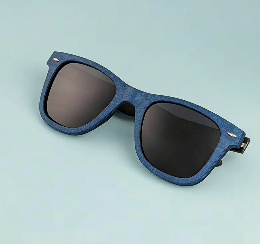 Blue sunglasses with dark lenses on a light blue background
